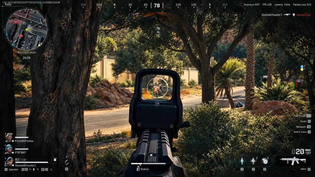 First-person view through a holographic sight at a sunlit road, with a red enemy outline visible in the optic.